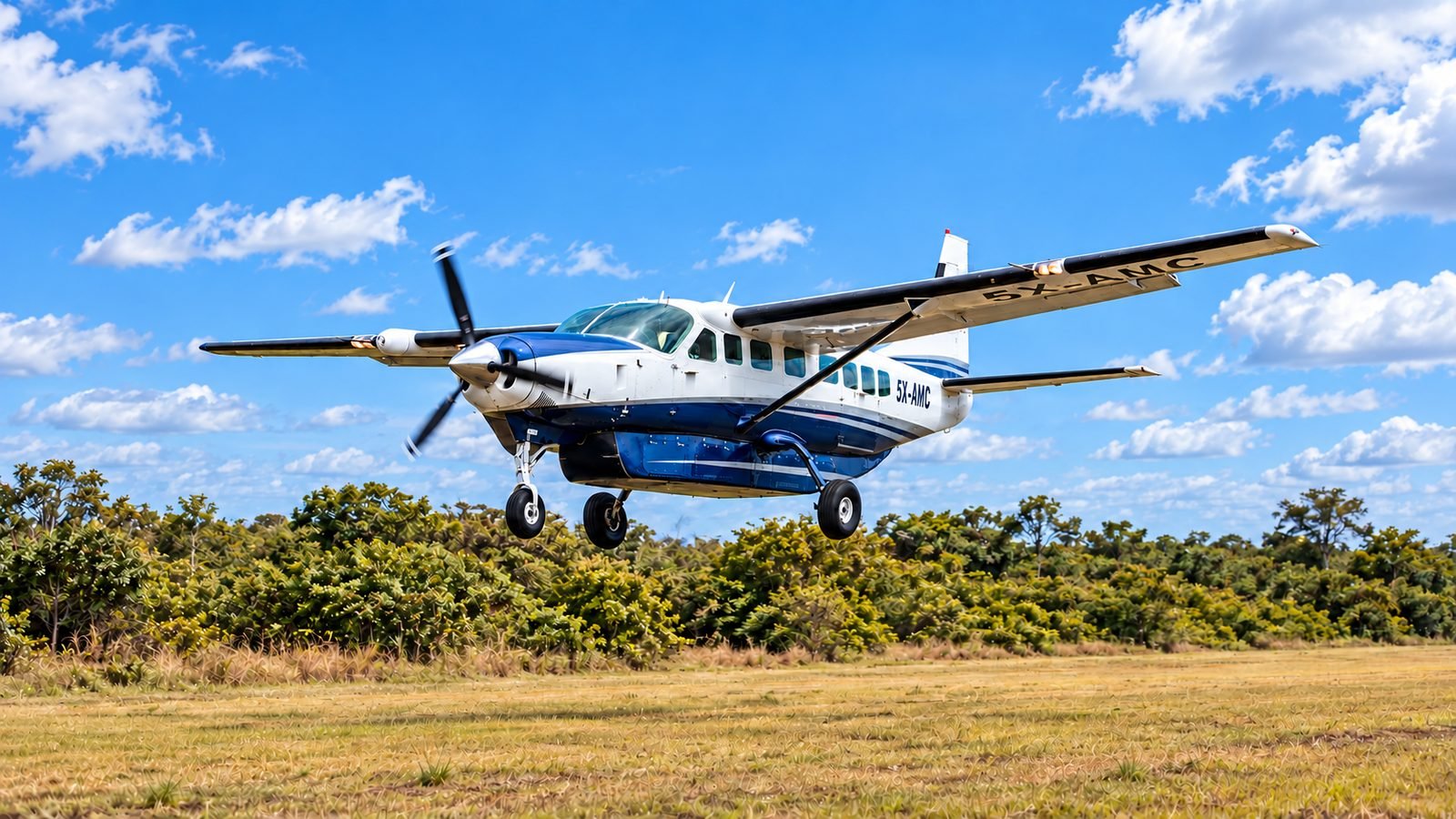 Asante Aviation Cessna Grand Caravan 5X-AMC on final approach to a grass airstrip in Uganda