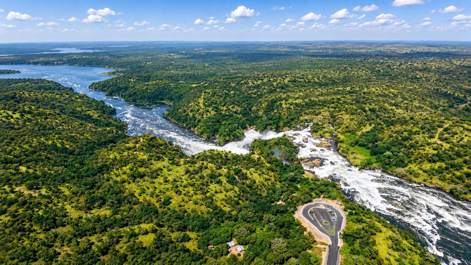 Aerial view of the Nile forcing through Murchison Falls, surrounded by green forest